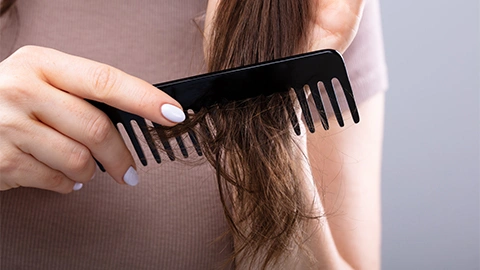 Die richtige Haarpflege bei Haarausfall. Haare bürsten mit Kamm