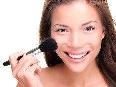 Frau trägt dekorative Kosmetik auf Frau trägt dekorative Kosmetik auf
